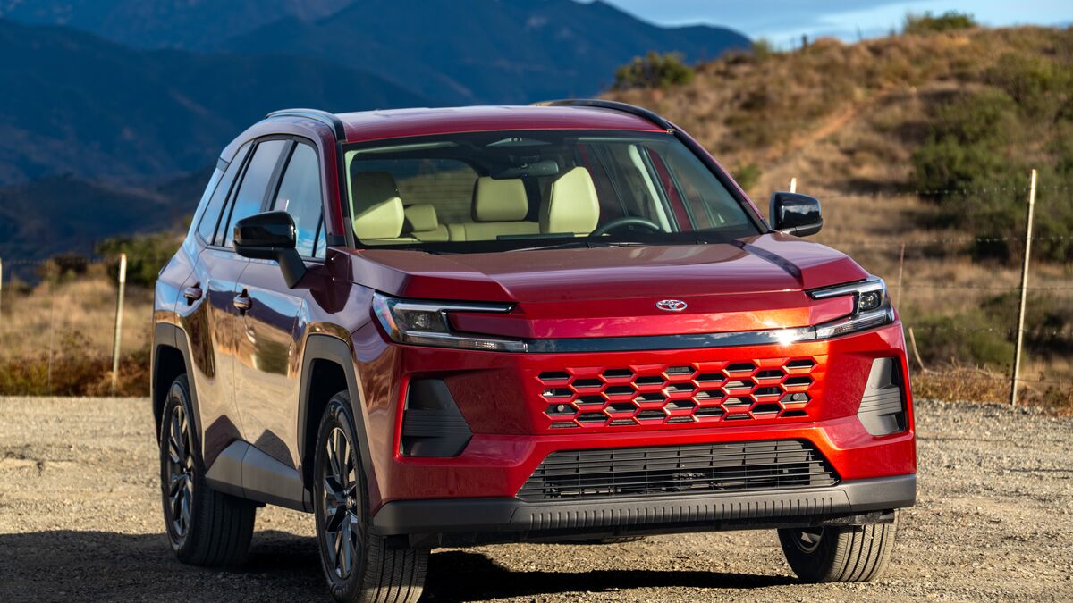 A front right 3/4 angle photo of a 2026 Toyota Rav4 XLE against a hilly backdrop under blue skies.