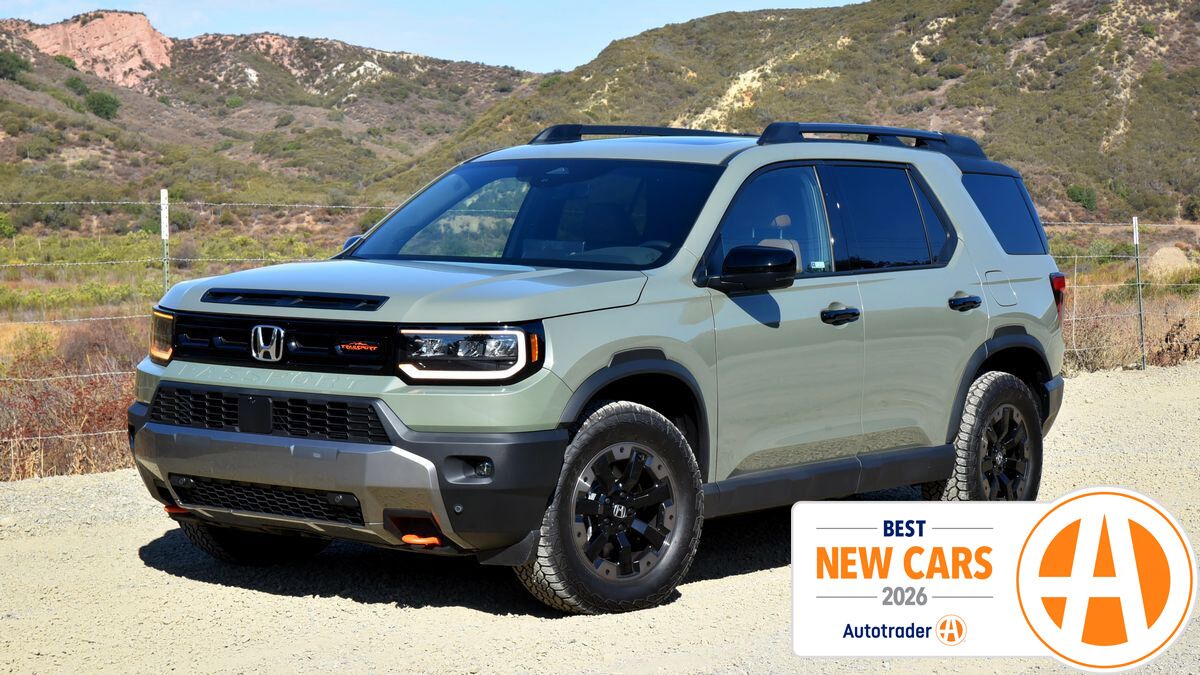 Honda Passport parked outside by a wired fence.