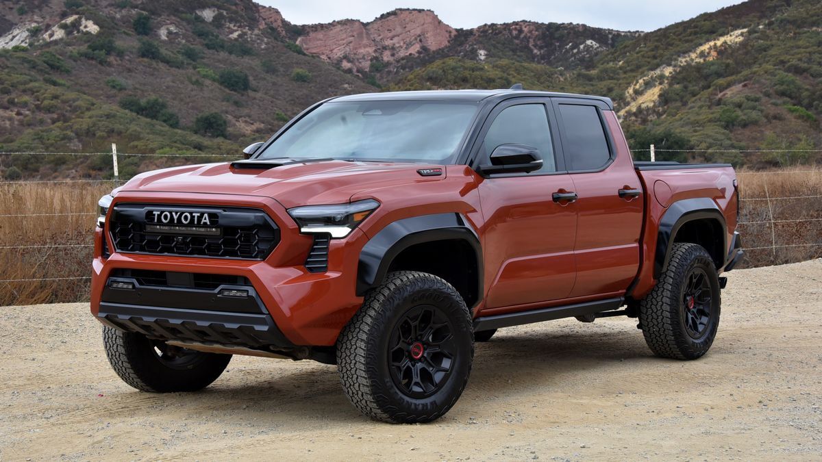 2025 Toyota Tacoma TRD Pro parked on dirt with red hills in the background.