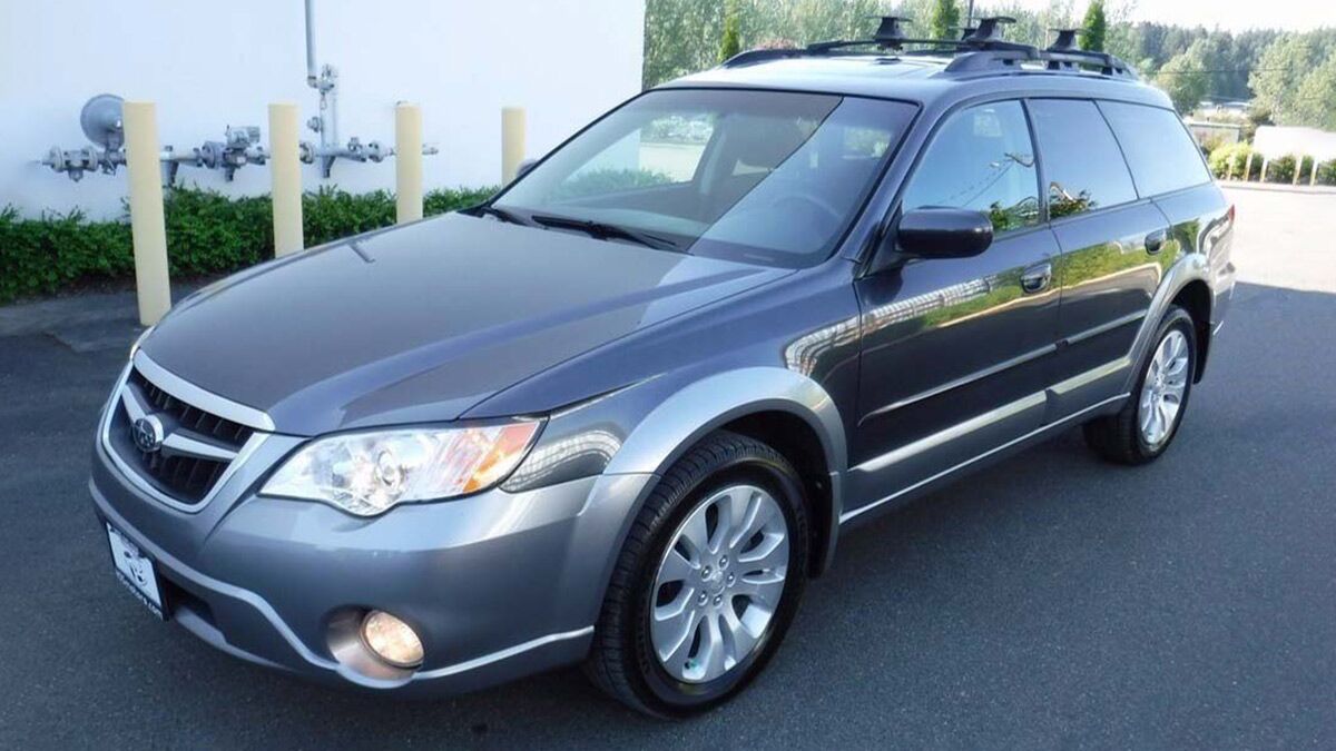 2007 Subaru Outback parked outside an office.