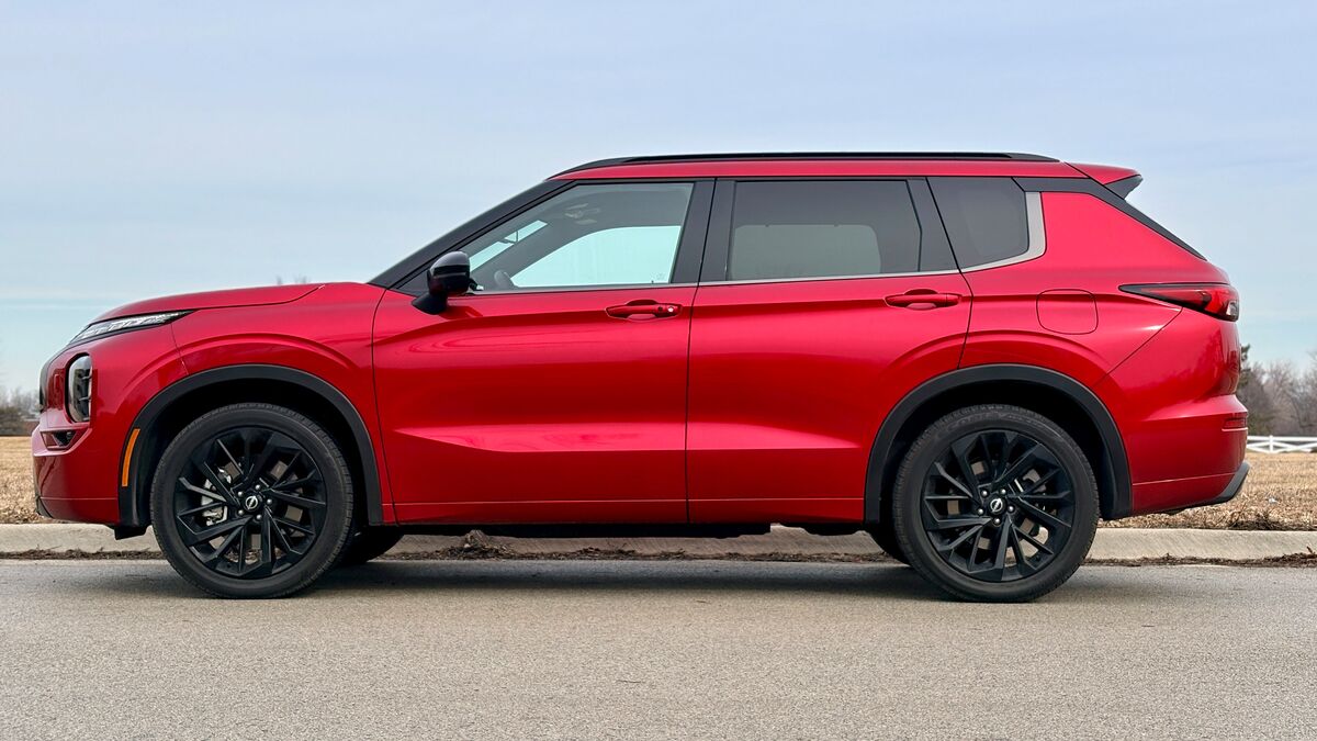 2026 Nissan Rogue PHEV in red parked outside.