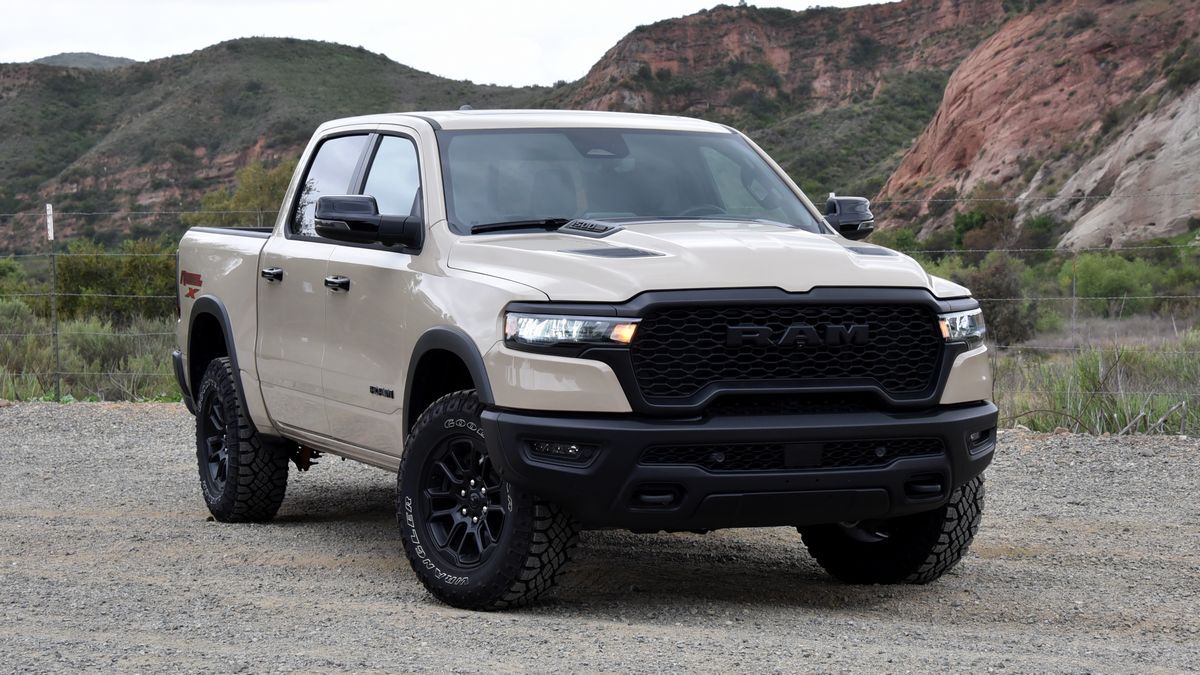2025 Ram 1500 Rebel X parked on a dirt road with red hills in the background.