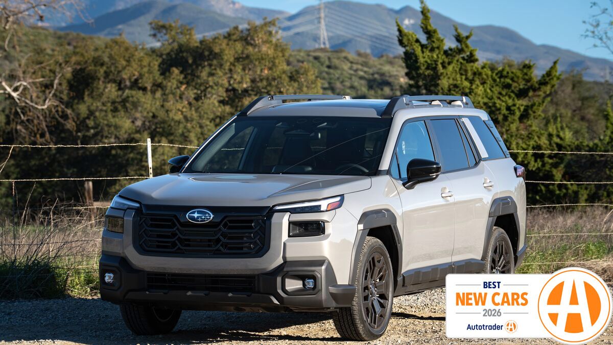 Subaru Outback parked in front of a wired fence.