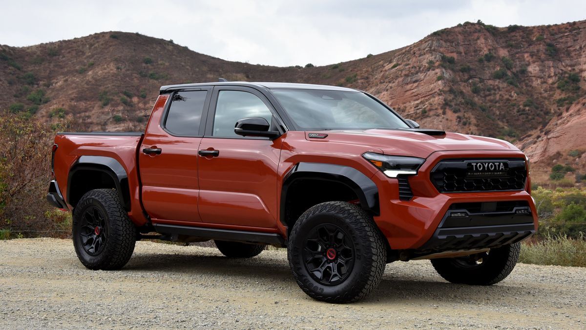 2025 Toyota Tacoma TRD Pro parked on dirt with red hills in the background.