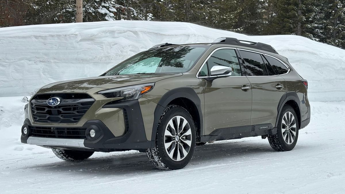 2025 Subaru Outback Touring parked near a snow bank.