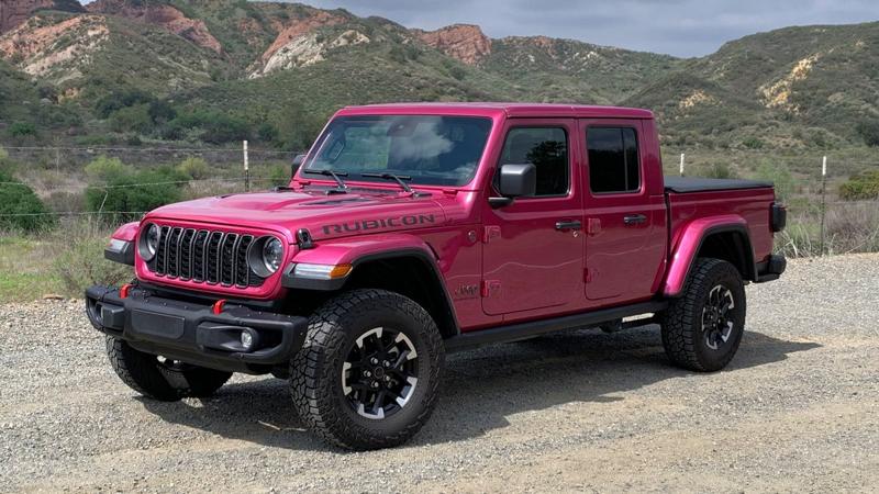 2025 Jeep Gladiator Rubicon parked on a dirt road with red hills in the backgound.