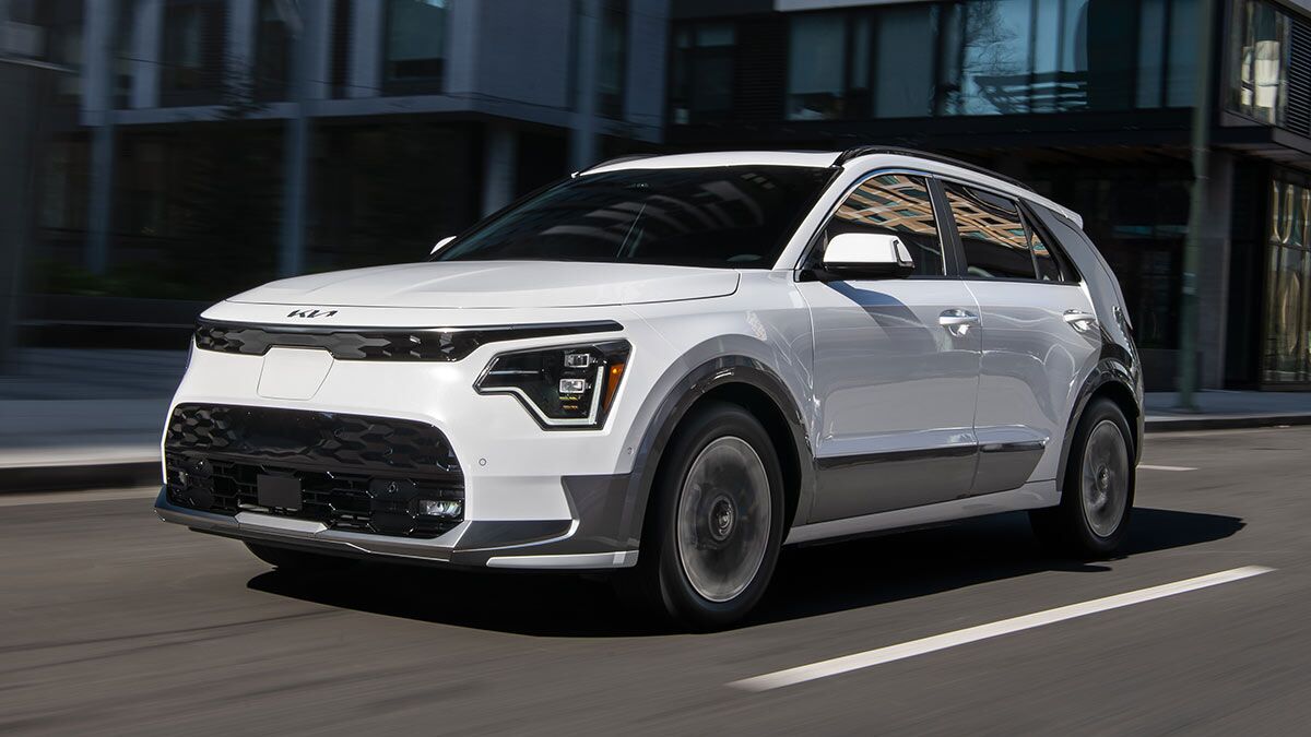 2025 Kia Niro EV in white, driving through the city.