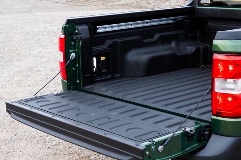 Pickup truck bed with tailgate open.