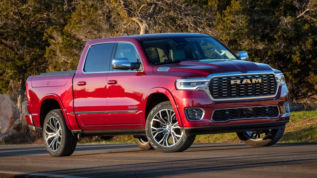 2025 Ram 1500 Tungsten in red with trees in the background.