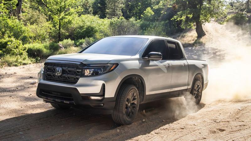 2026 Honda Ridgeline RTL driving on a dirt road.