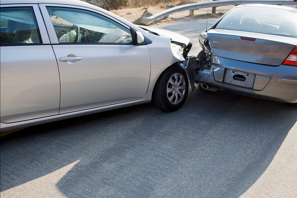 Broken car after a traffic accident in the parking lot of a repair station.  Car body