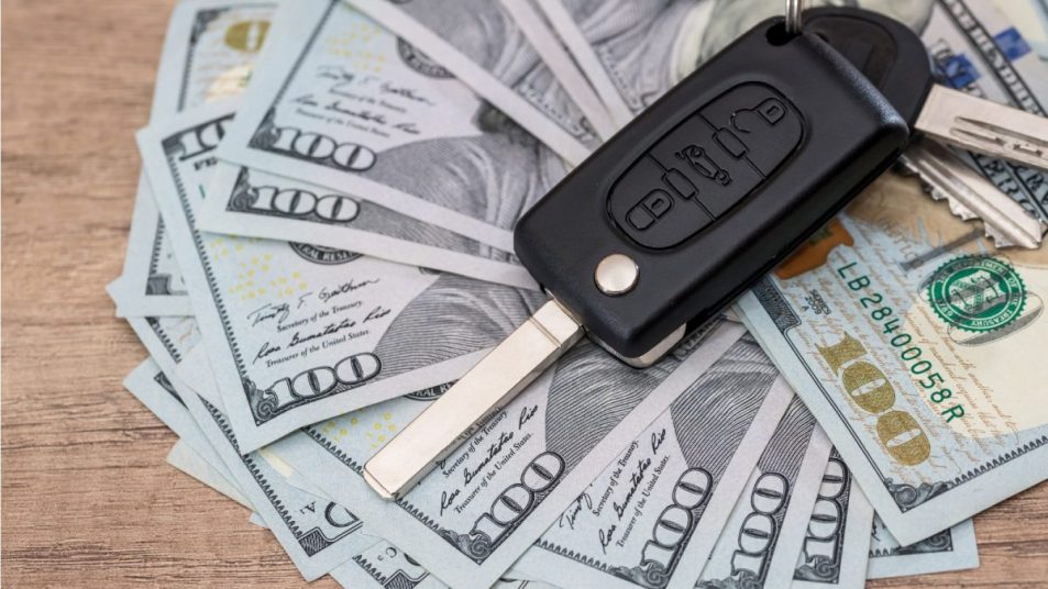 Cash with car key on top 