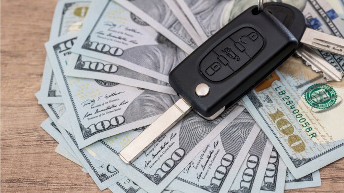 Cash with car key on top 