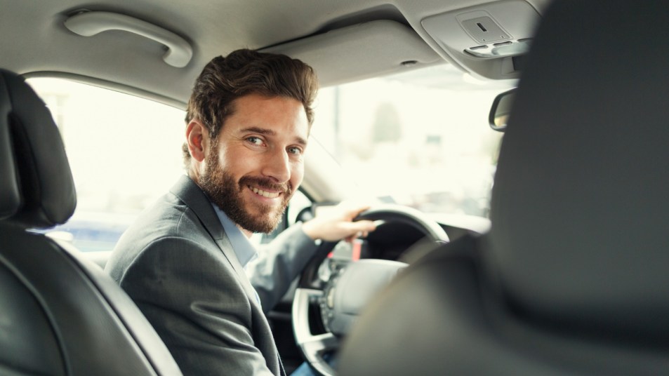 Man in Car showing car spec of headroom