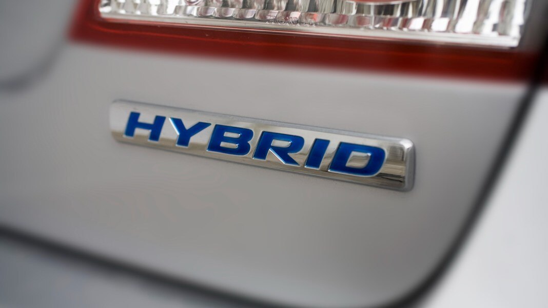 Hybrid badge under tail light