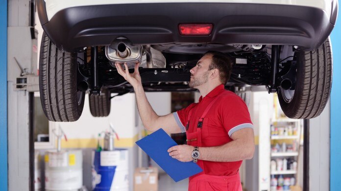 muffler shop inspecting catalytic converter