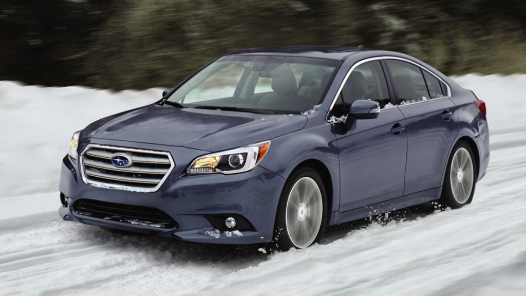 2017 Subaru Legacy in blue, driving in the snow.