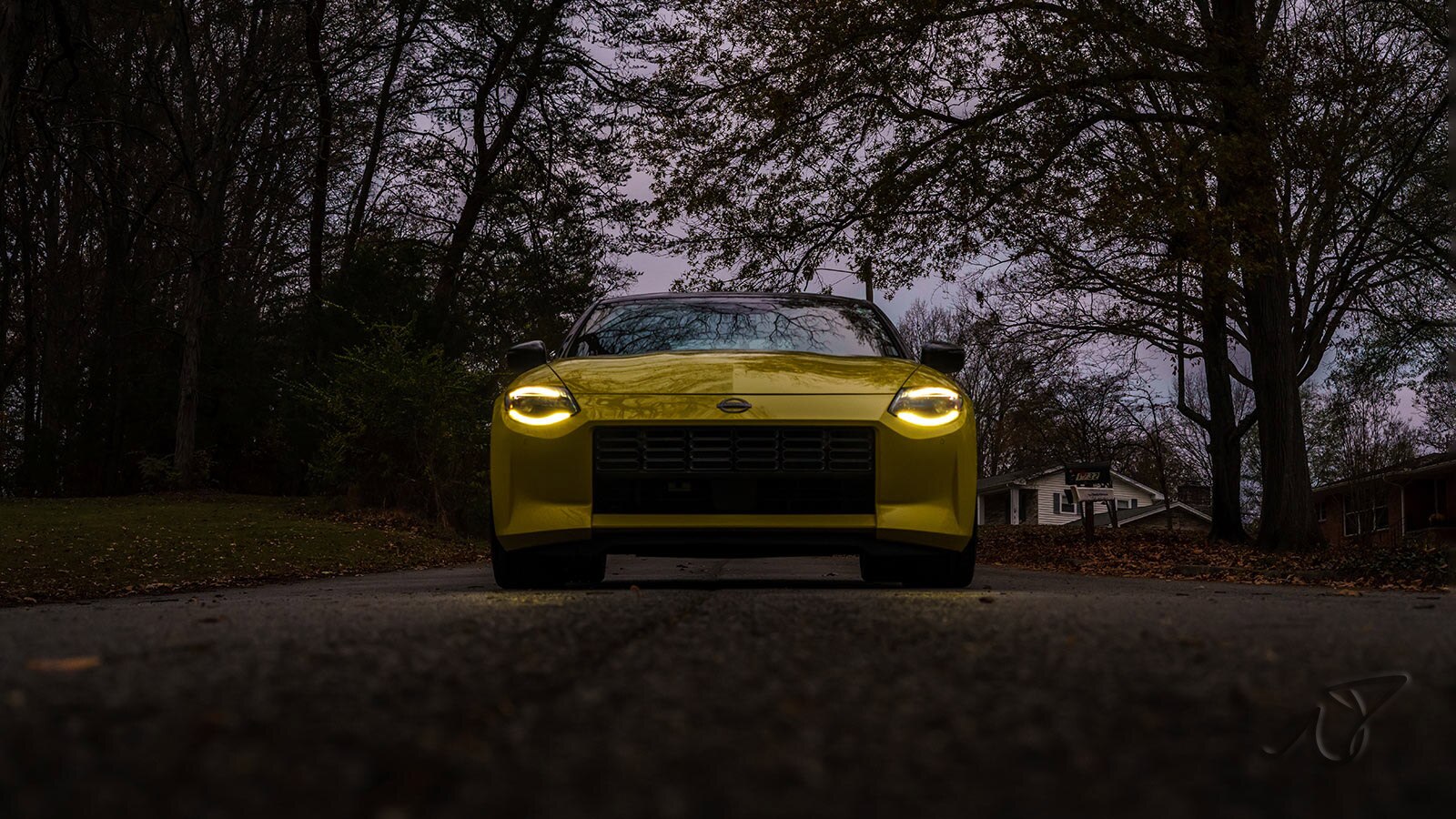 Nissan Z Performance lower front at dusk in yellow