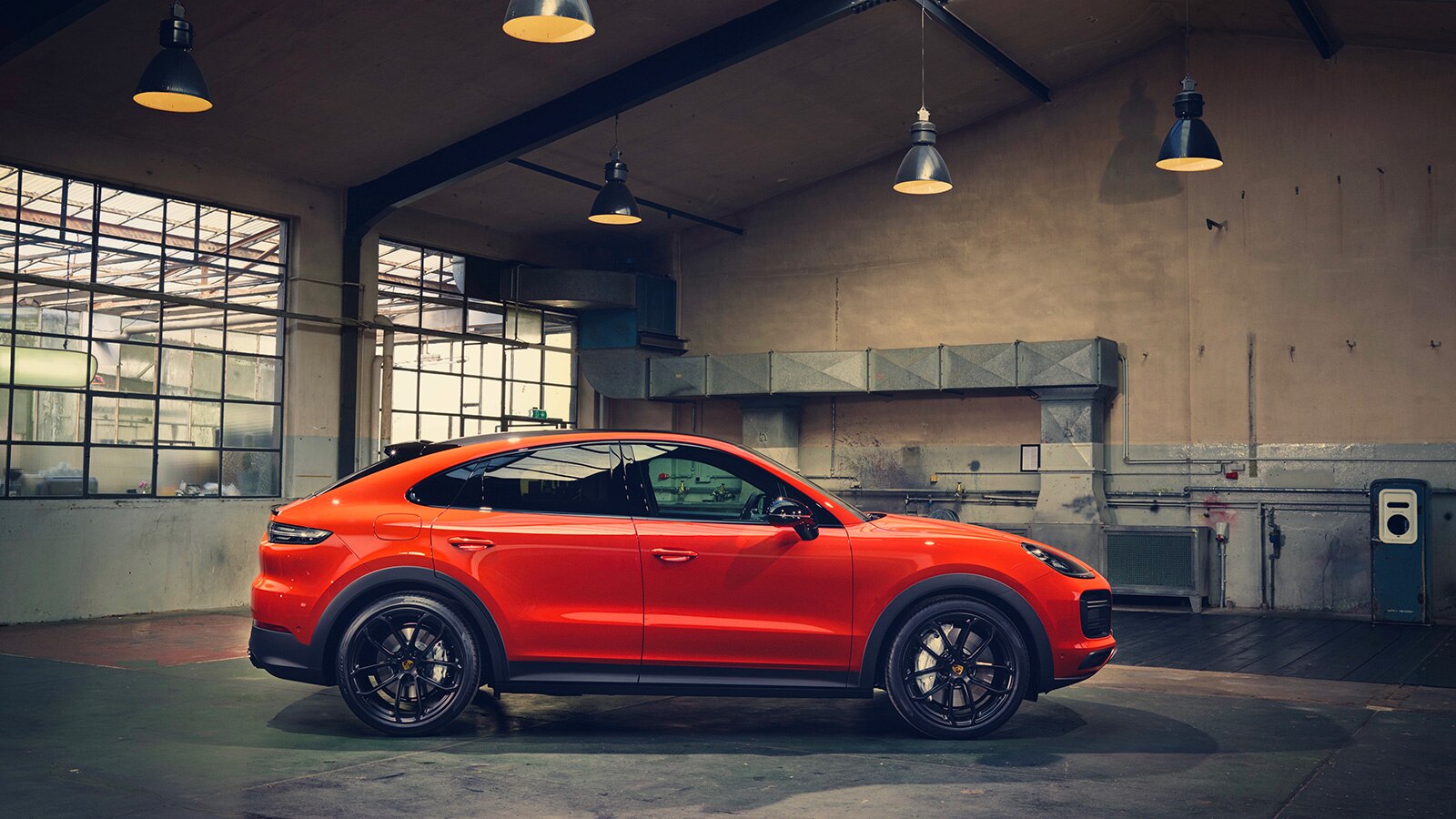 2023 Porsche Cayenne Coupe profile indoors in orange
