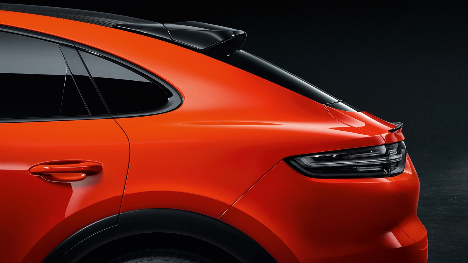 2023 Porsche Cayenne Coupe rear half profile driver side in orange