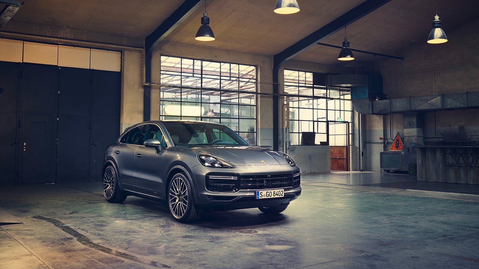 2023 Porsche Cayenne Coupe Turbo front right wide angle in metallic grey