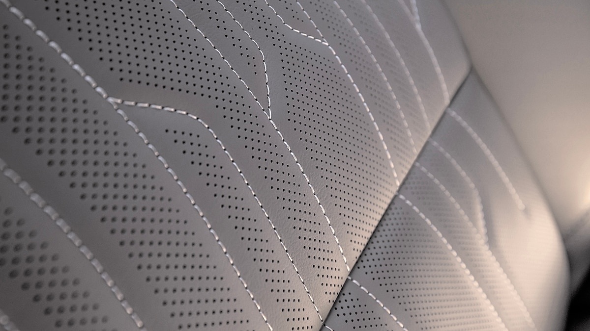 Close-up view of the interior stitching on the front passenger side seat of the 2024 Buick Envista Avenir. Preproduction model shown. Actual production model may vary. Available in summer 2023.