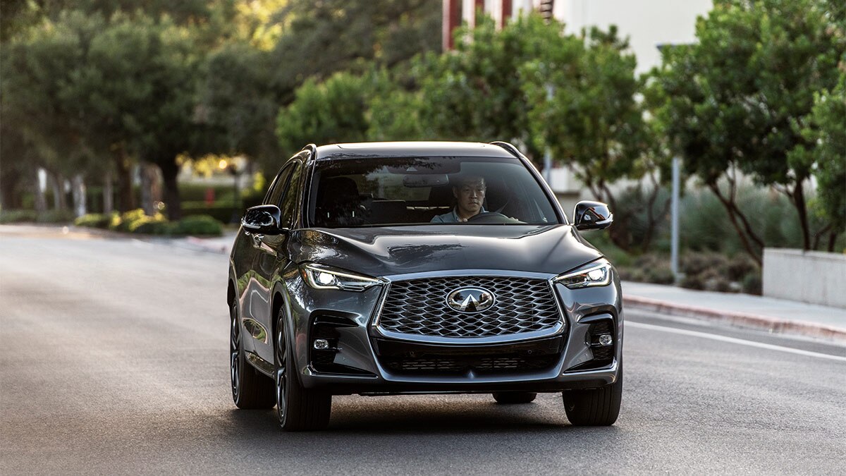 A 2024 Infiniti QX55 driving in the city.