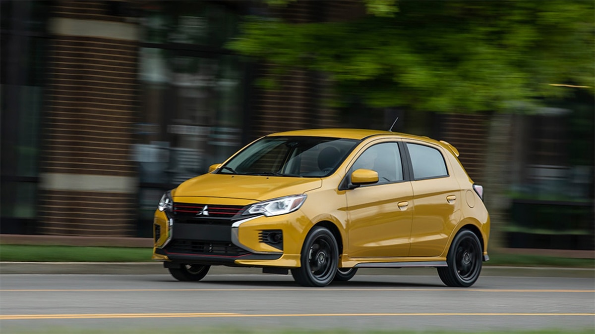The 2024 Mitsubishi Mirage driving in the city.