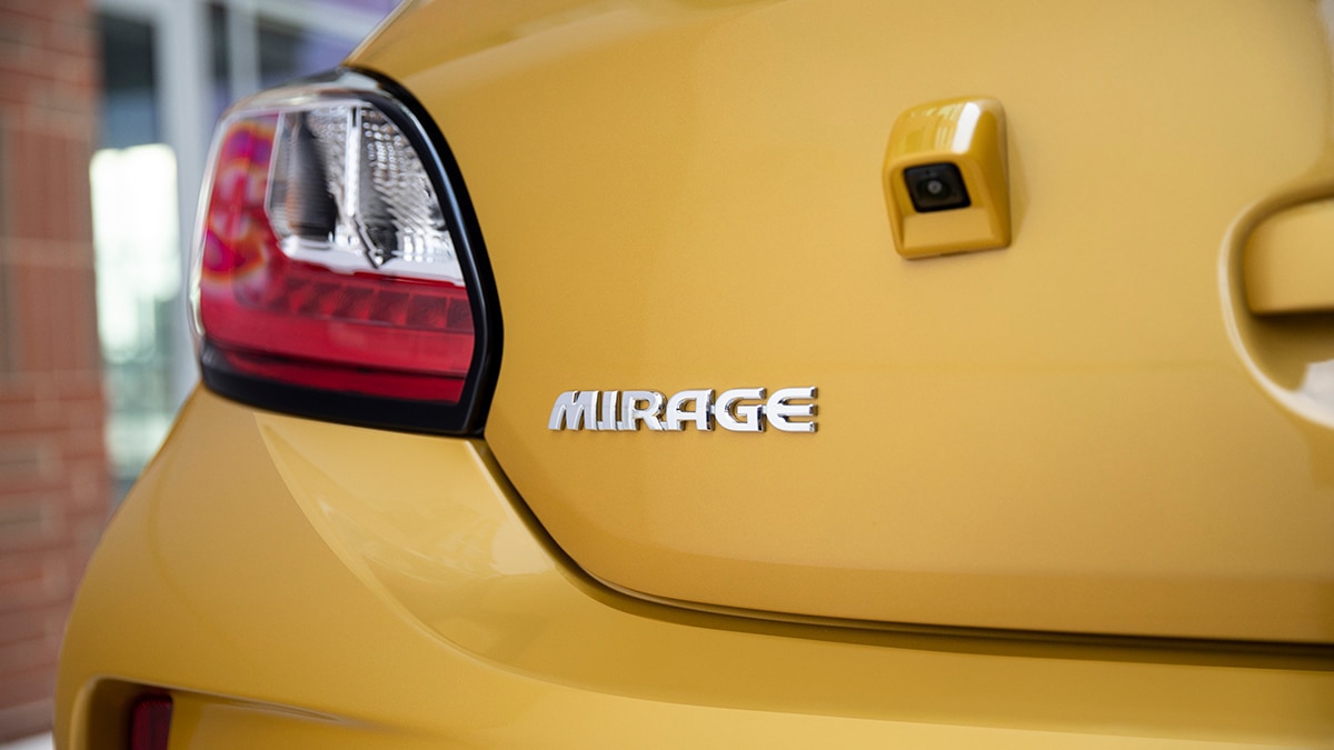 Mirage badge on a 2024 Mitsubishi Mirage in mustard yellow.