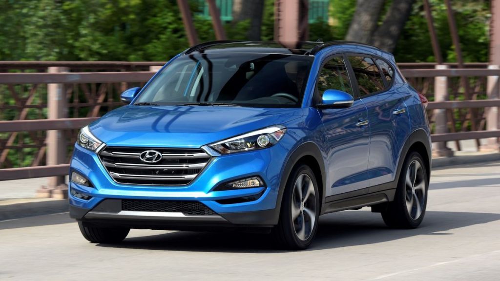 2018 Hyundai Tucson in blue driving on a bridge.