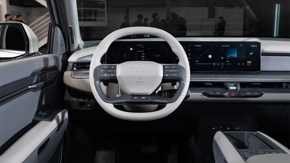 A boxy exterior makes for a spacious EV9 cockpit, one with logically arranged controls and a handy volume roller wheel. . 