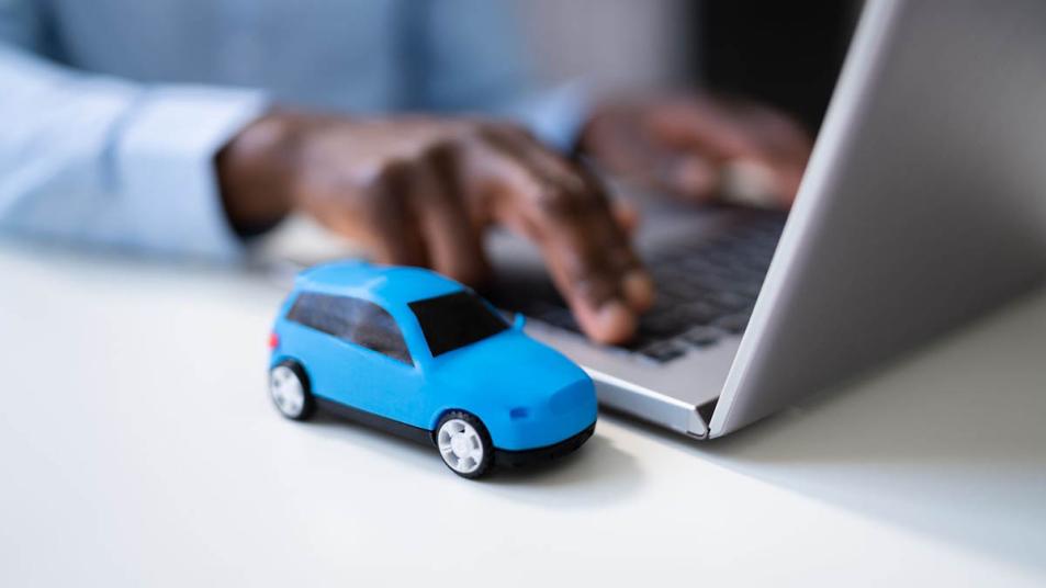 A person using computer for car shopping.
