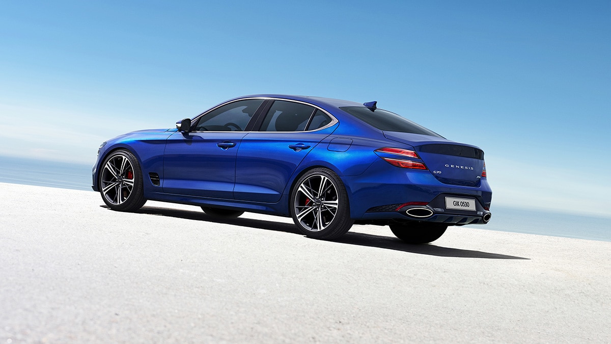 The 2024 Genesis G70 in Kawah Blue paint, a $575 option.  Note the dual exhaust outlets. 