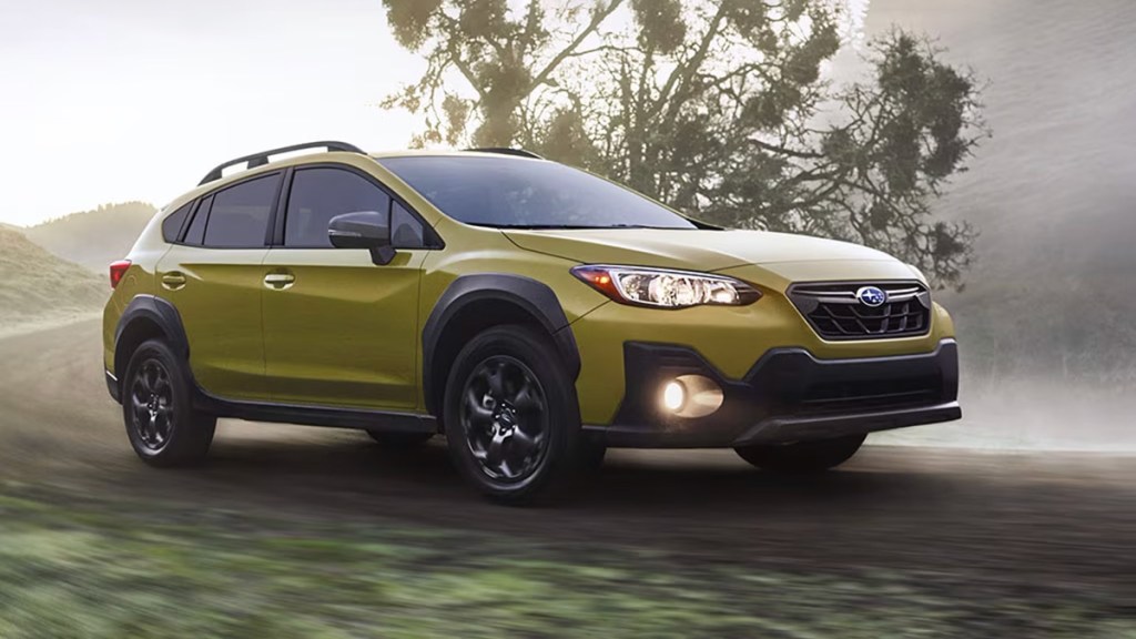 2021 Subaru Crosstrek in green driving on the road.