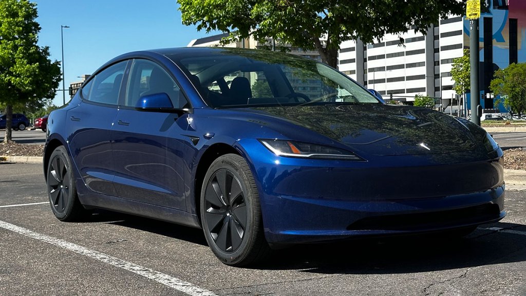 2024 Tesla Model 3 in blue parked outside.