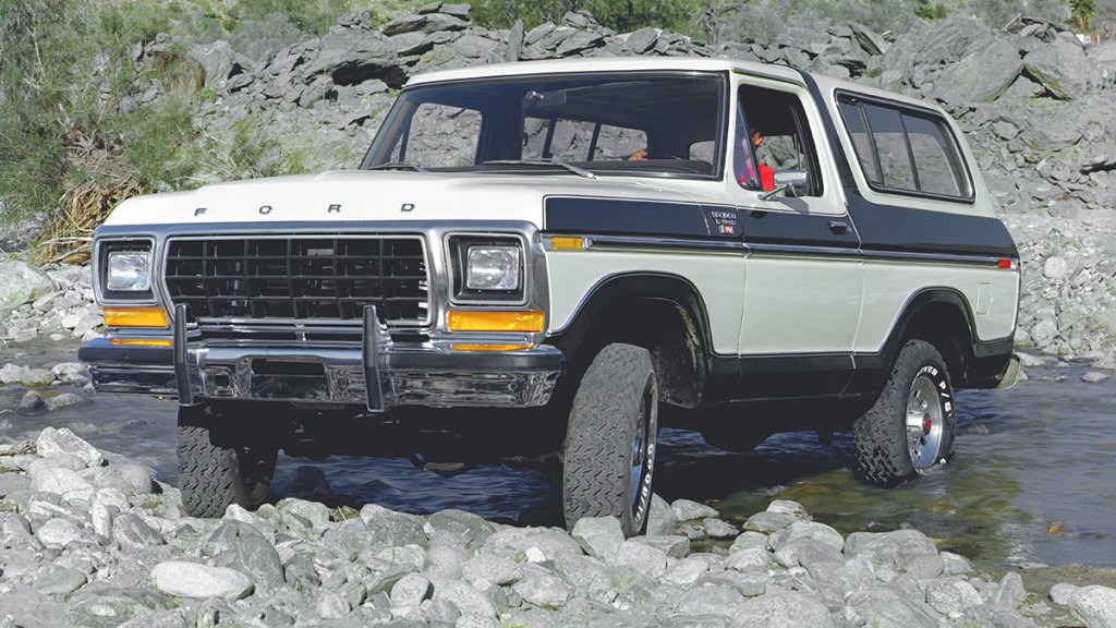 1979 Ford Bronco parked on rocks.