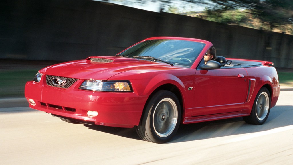 2002 Ford Mustang in red on the road.