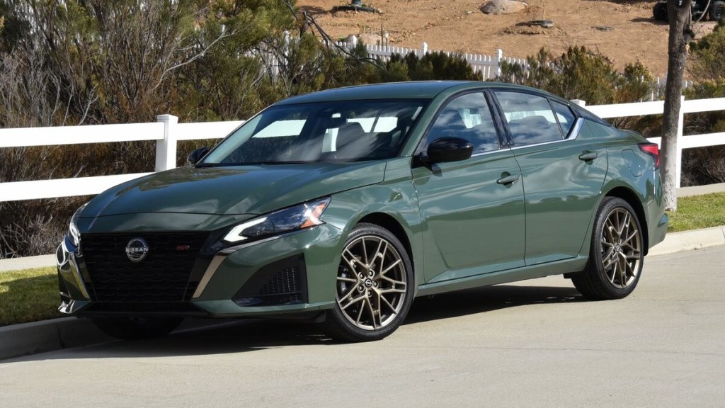 2025 Nissan Altima in green parked by a barn.