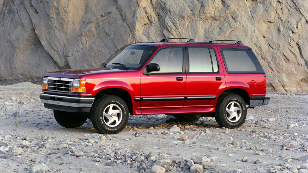 1994 Ford Explorer in red by a mountain.