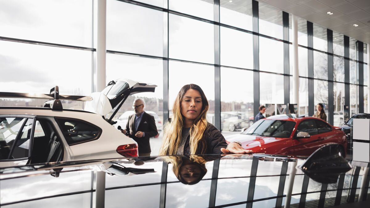 Customers-looking-at-cars-in-showroom