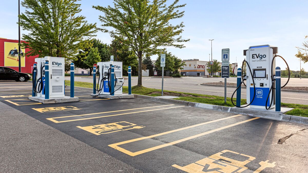EVgo electric car charging stations in a shopping center parking lot.